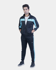 Person wearing a black and blue tracksuit on a white background