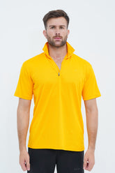 Man wearing a yellow short-sleeve shirt with a zipper on a white background