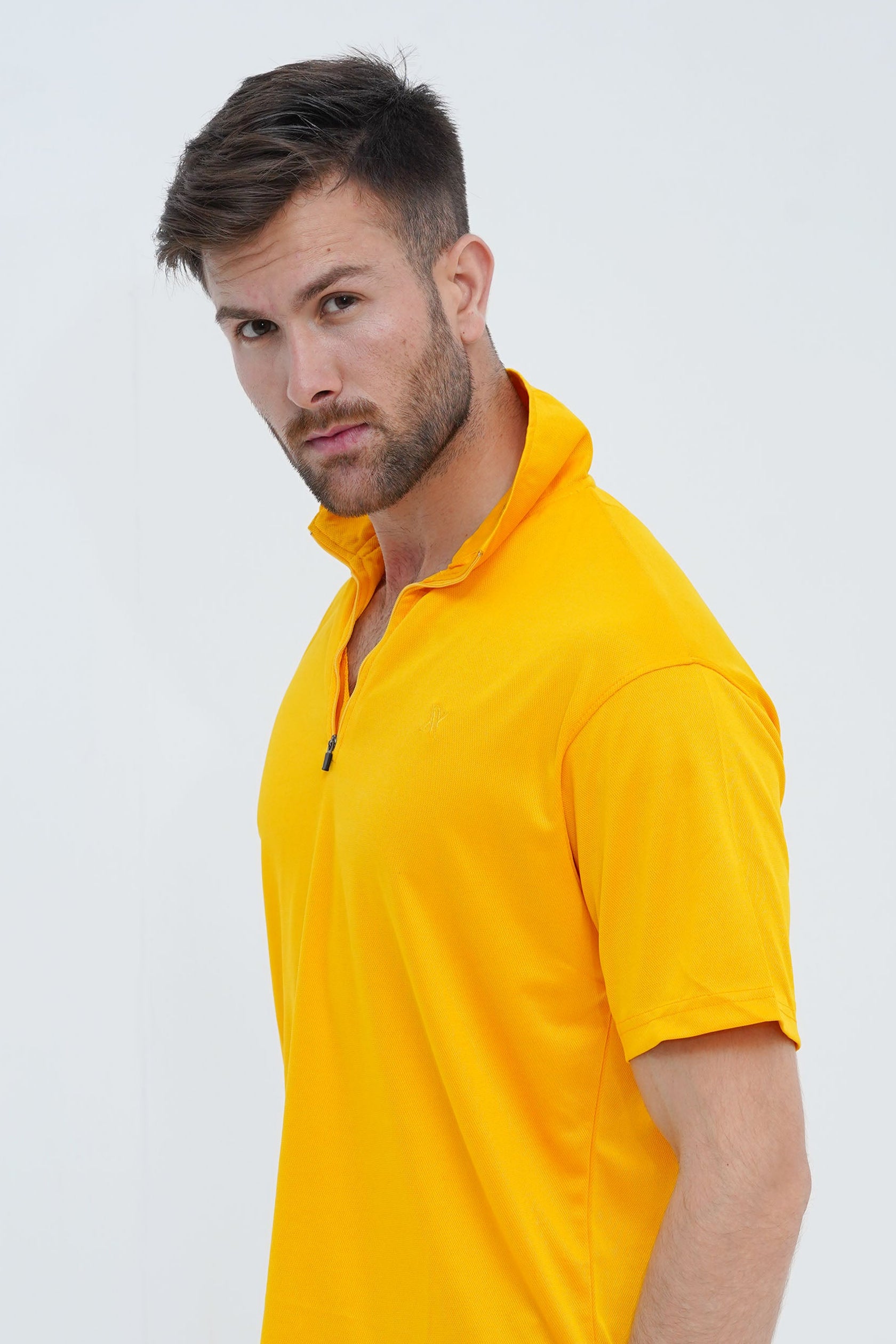 Man wearing a yellow polo shirt on a white background