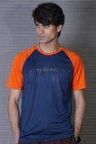 Man wearing a blue and orange t-shirt with 'day dreams' text against a gray background