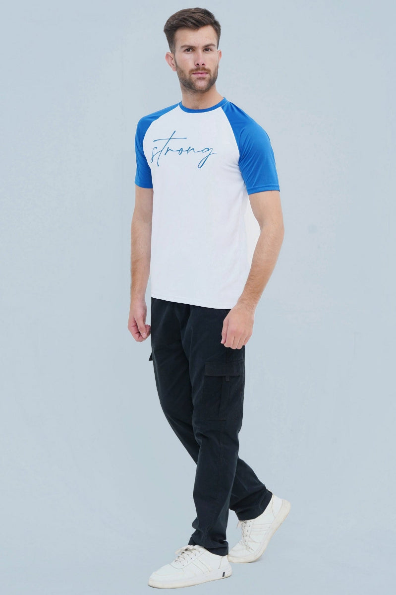 Man wearing a white and blue baseball shirt with 'strong' printed on it, standing against a light gray background.