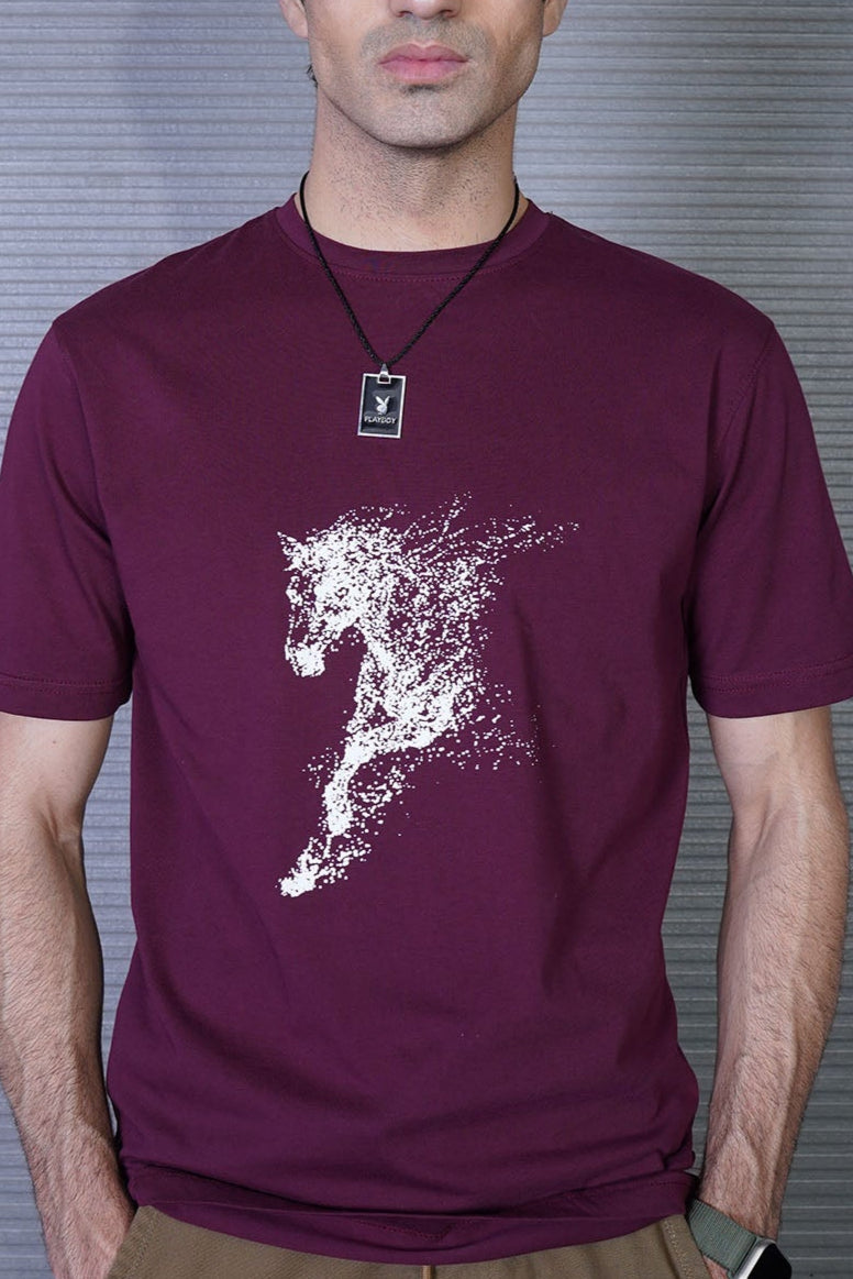 Man wearing a maroon t-shirt with a white graphic design on a striped background