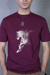 Man wearing a maroon t-shirt with a white graphic design on a striped background