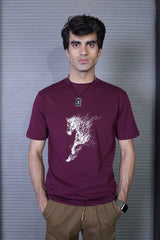 Man wearing a maroon t-shirt with a white graphic design on a striped background