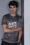 Person wearing a gray t-shirt with 'Skate Boarding' text against a light-colored wall.