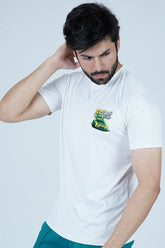 A man wearing a white t-shirt with a colorful graphic on the front, standing against a neutral background.