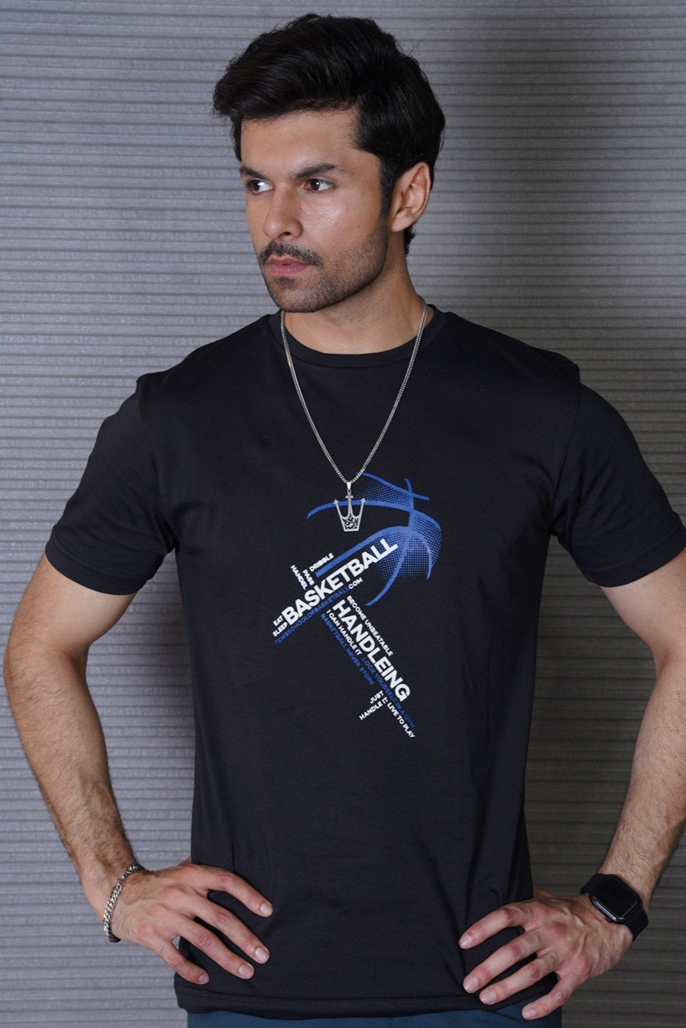 Man wearing a black t-shirt with a graphic design against a gray background