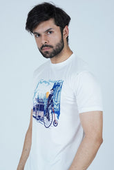 Man wearing a white t-shirt with a graphic design on a light gray background