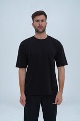 Essential black drop shoulder T-shirt for men – oversized fit, premium cotton, and a sleek, modern aesthetic.