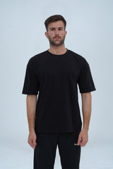Essential black drop shoulder T-shirt for men – oversized fit, premium cotton, and a sleek, modern aesthetic.