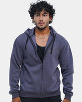 Man wearing a purple hoodie against a light gray background
