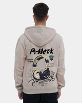 Person wearing a beige hoodie with a graphic design on the back against a light gray background