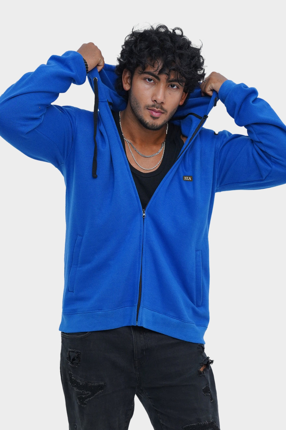 Person wearing a blue hoodie on a white background