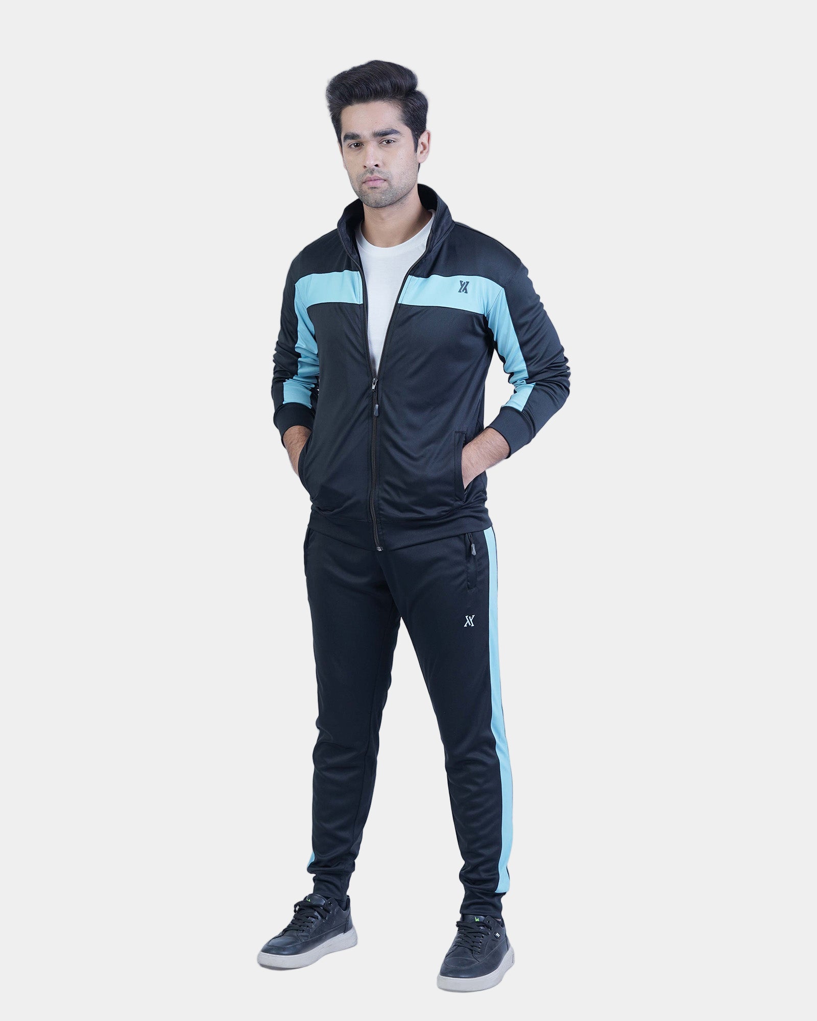 Person wearing a black and blue tracksuit on a white background