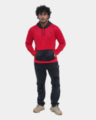Man wearing a red and black hoodie with cargo pants on a light gray background