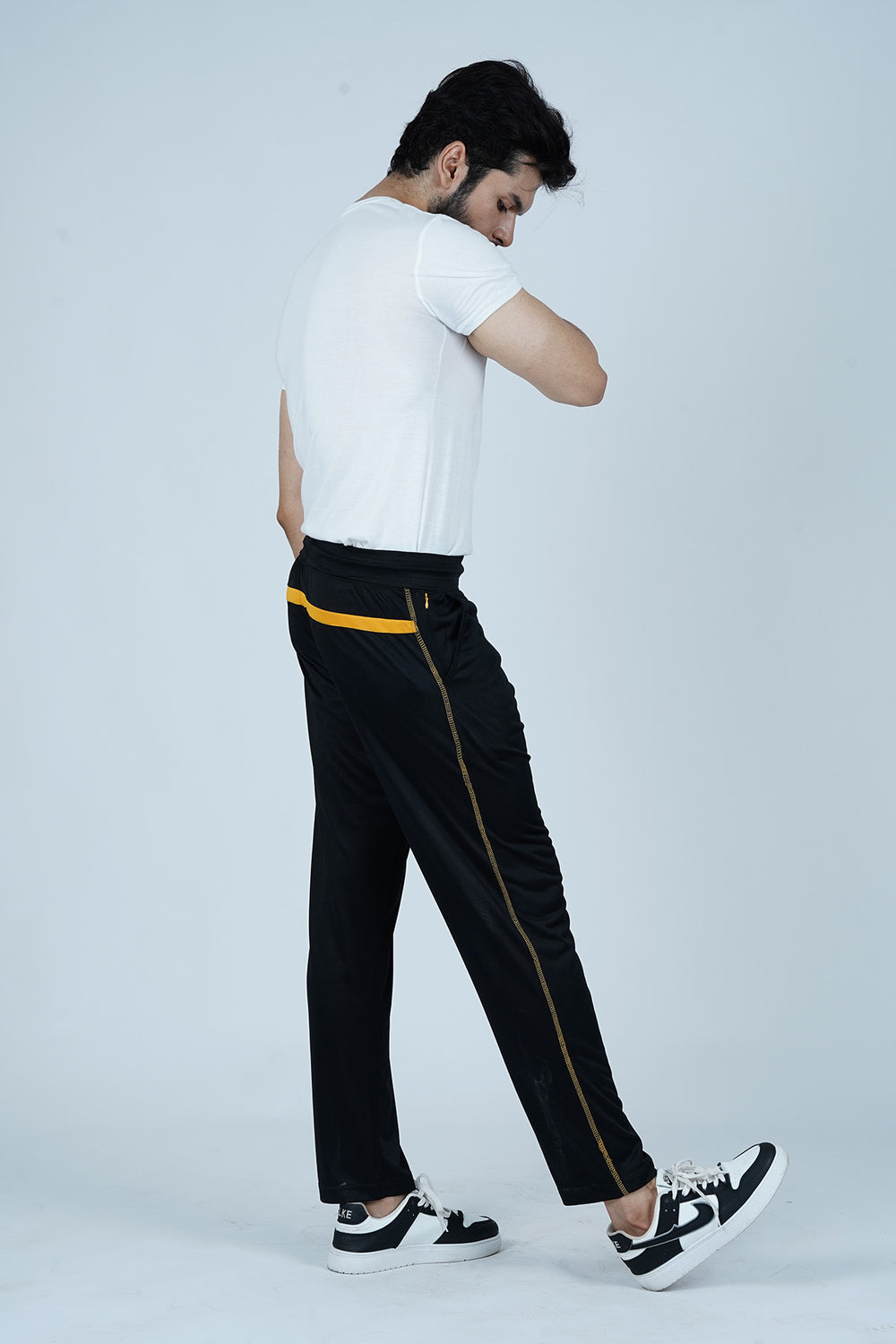 Step up your casual style with these Black Joggers for Men with Yellow Accents. Designed with a unique yellow back panel, yellow side stitching, and a hidden zip pocket, these joggers offer both style and secure storage. Whether for the gym, outdoor adventures, or relaxed days, these joggers bring comfort and a bold look to any outfit.