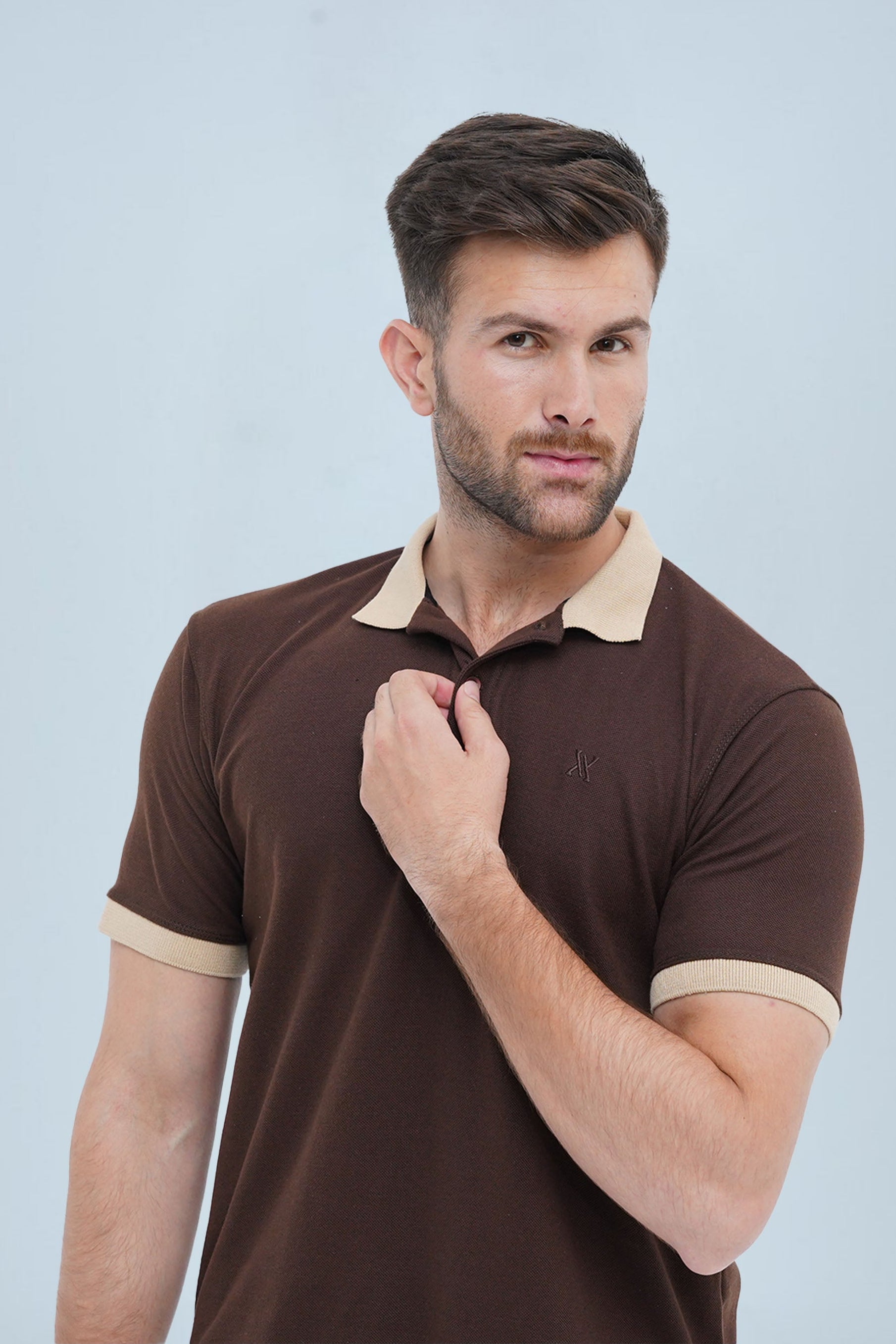 A fashionable men's short-sleeve polo shirt in brown with beige detailing, ideal for casual outings and office wear.