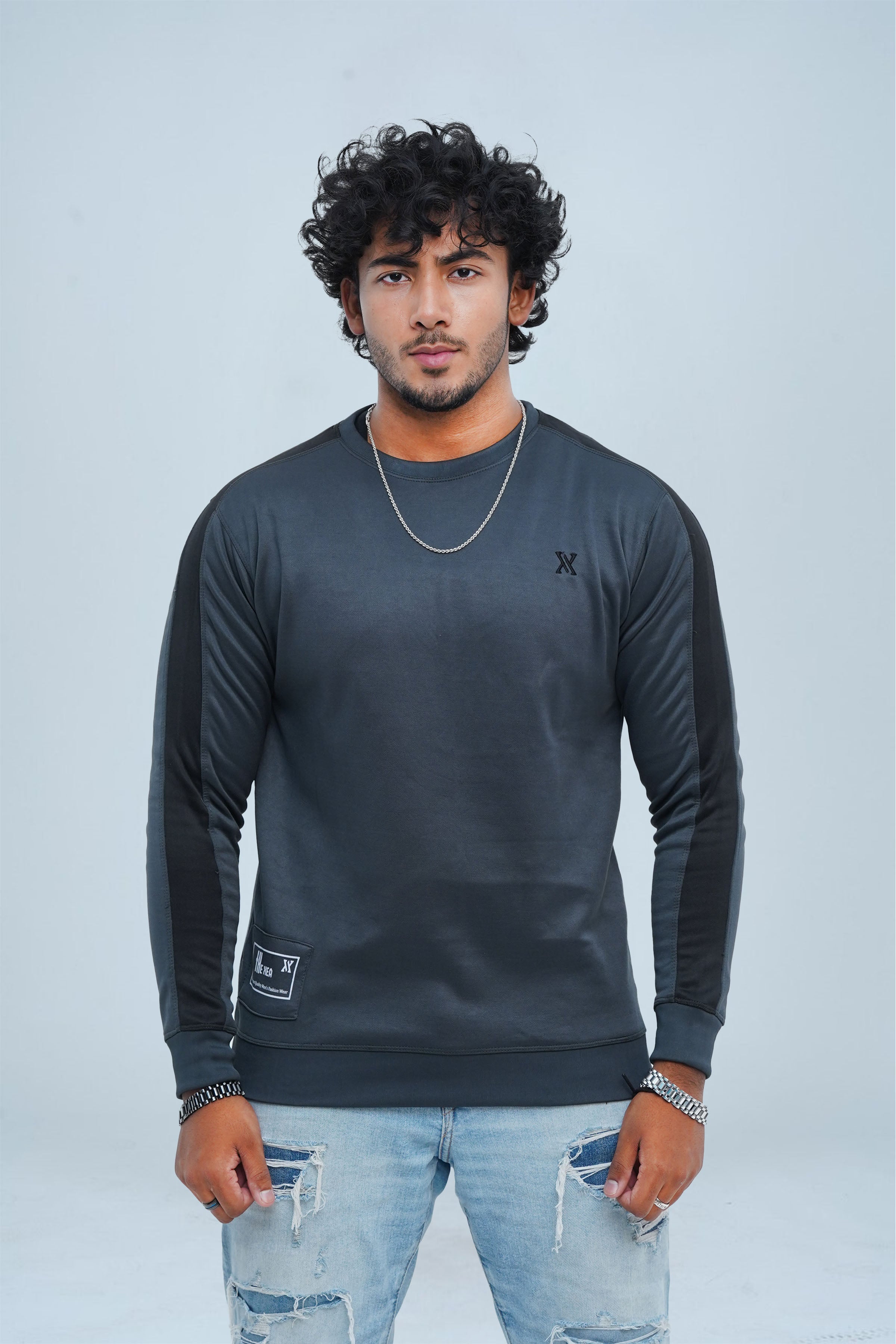 Get winter-ready in our men's grey Sweatshirt! Stay warm and stylish with quality materials and a perfect fit. Bold black panel on sleeves adds a touch of excitement to your look.