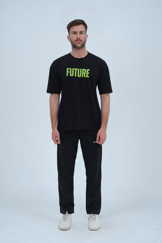 A black oversized drop-shoulder T-shirt with bold green "FUTURE" lettering on the front, making a strong statement in streetwear fashion.