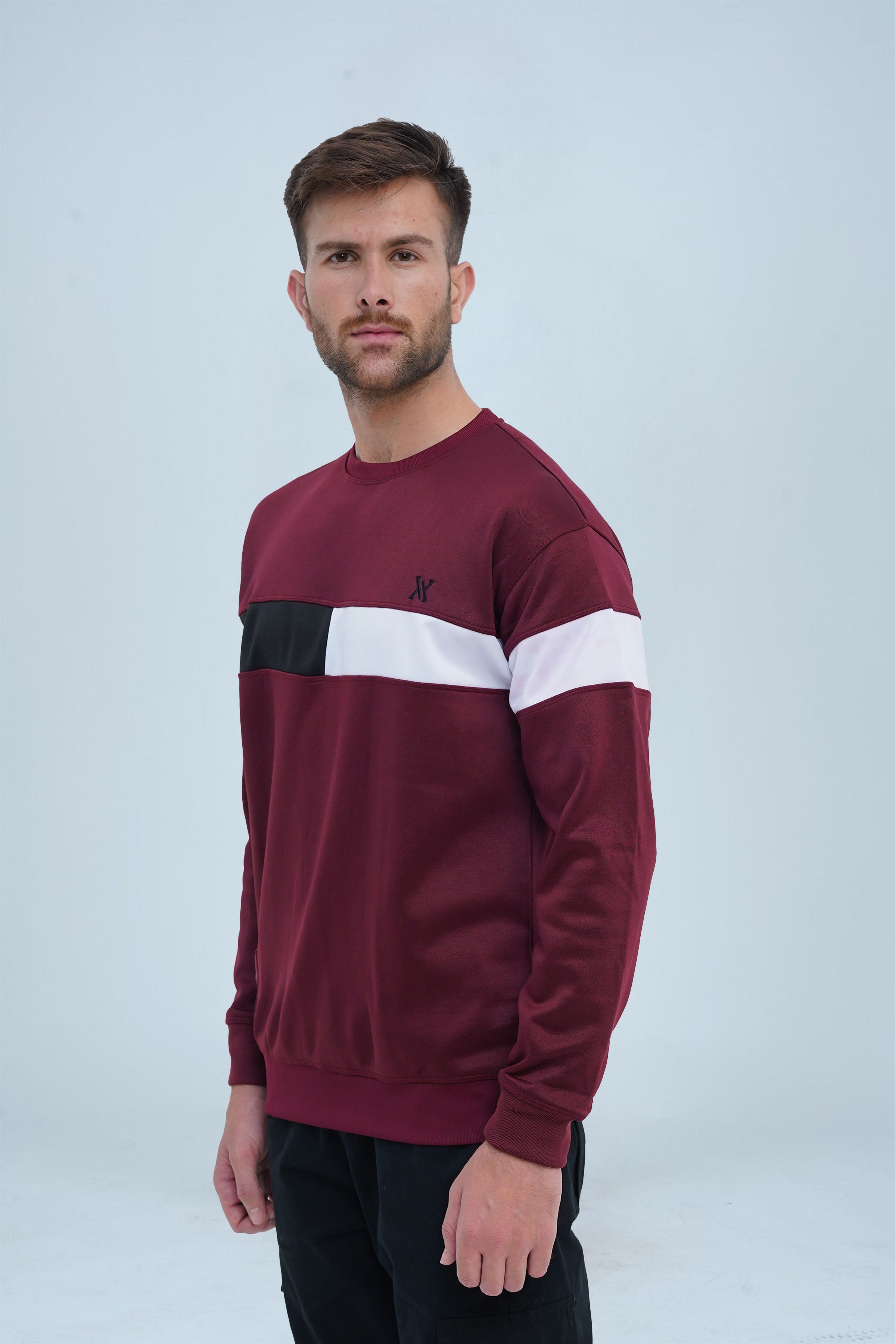 A casual maroon pullover adorned with a black and white chest stripe, perfect for layering or standalone wear