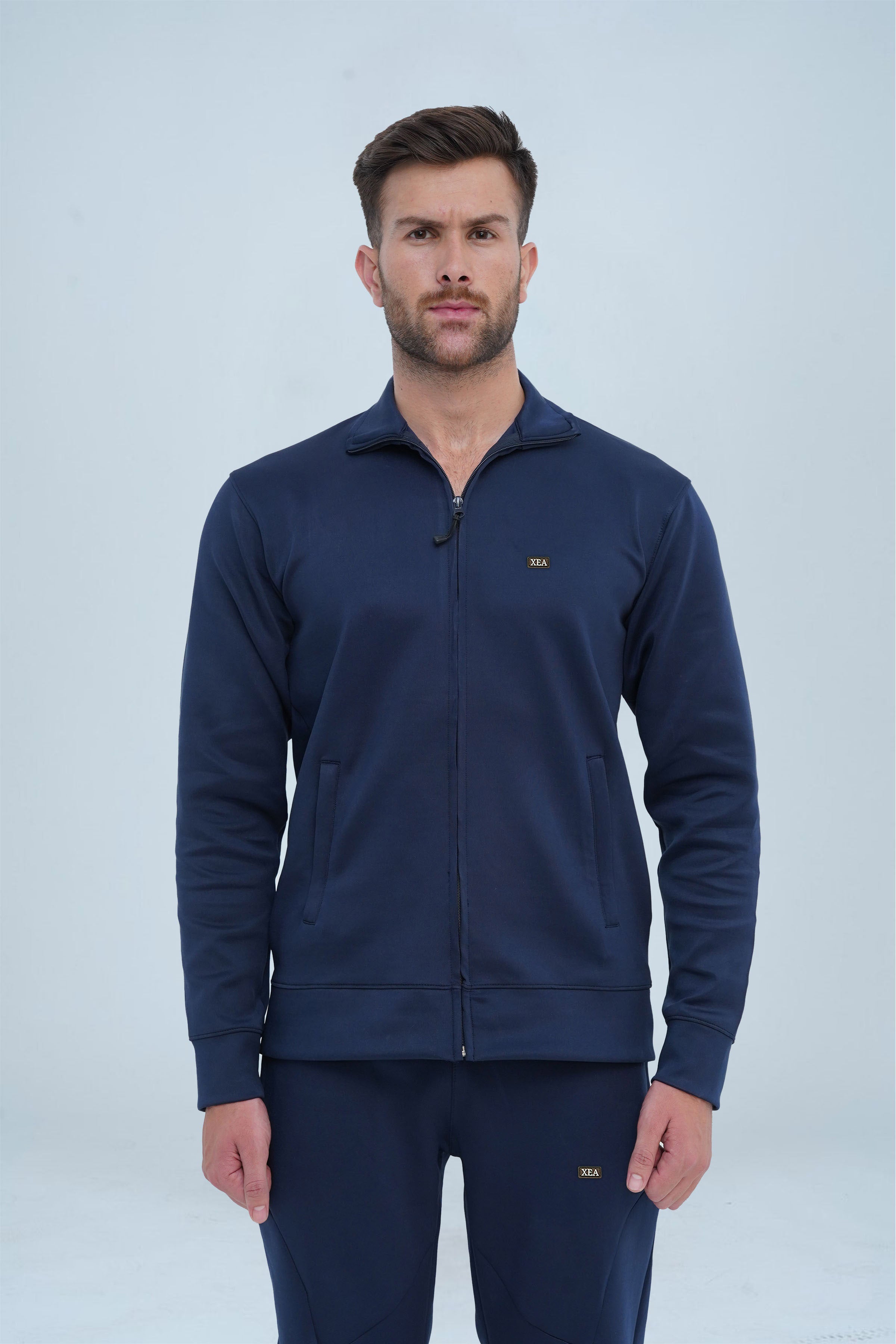 Elevate your winter workout attire with our Men's Warm Up Winter Tracksuit in navy. Ideal for athletes and active individuals, this tracksuit offers warm and flexible fabric. Stay both fashionable and at ease during workouts or casual activities with this must-have tracksuit.