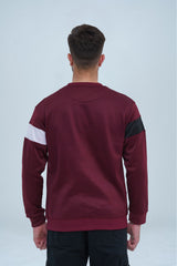 Rich maroon sweatshirt with a contrasting black and white stripe on the chest, adding a touch of athletic flair to the design -  Color Block Maroon Sweatshirt - Xea Clothing