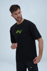 Black oversized t-shirt with "Ride Fast" neon green graphic on the front, perfect for bikers and streetwear lovers.