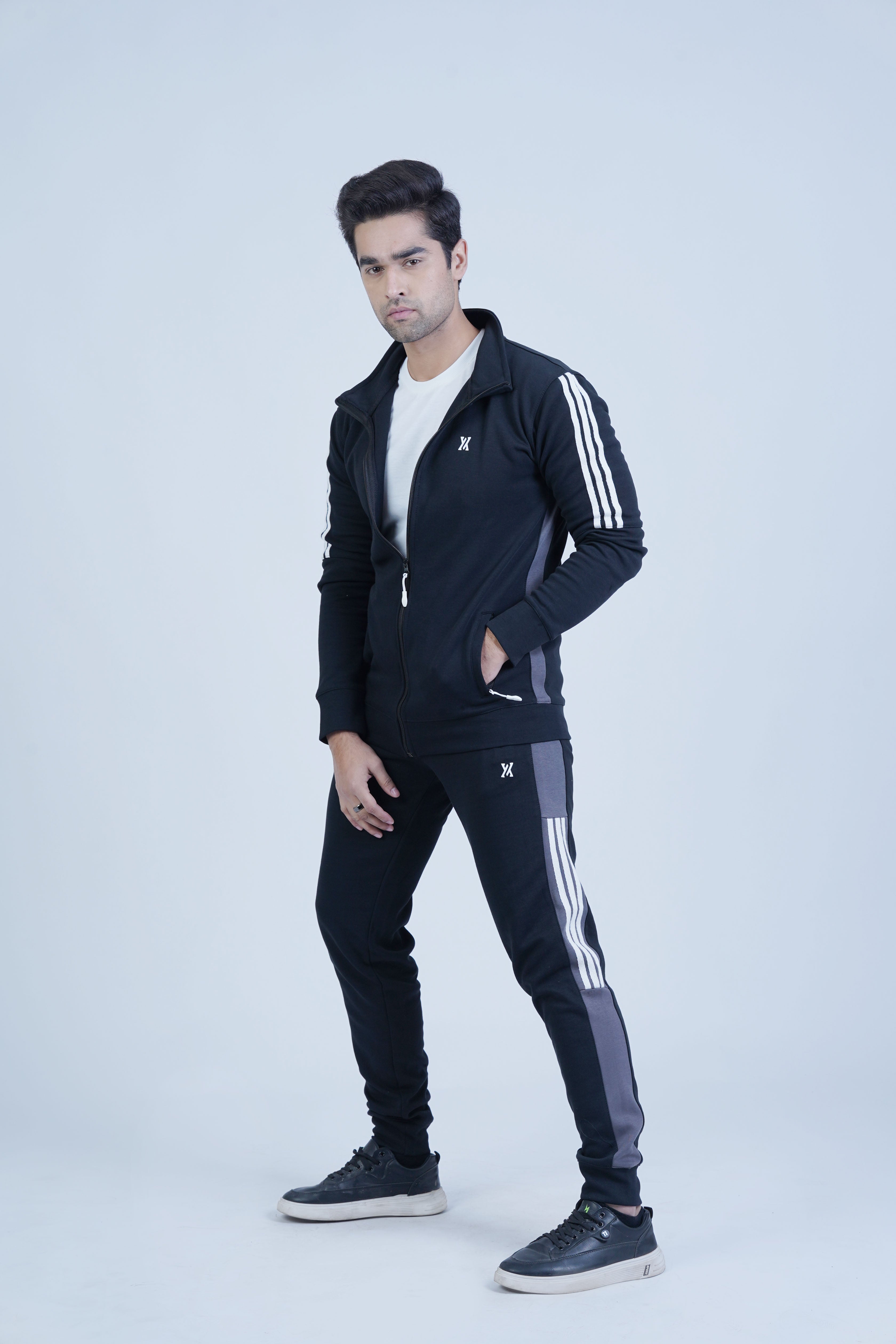 Conquer winter in style with our Special Edition Winter Tracksuit for men. With a sleek black base, standout smoke grey panels, and trendy half three stripes in white, this tracksuit is perfect for the modern athlete.