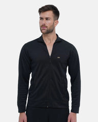 Man wearing a black zip-up sweatshirt with a visible brand logo on a light gray background