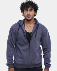 Man wearing a purple hoodie against a light gray background