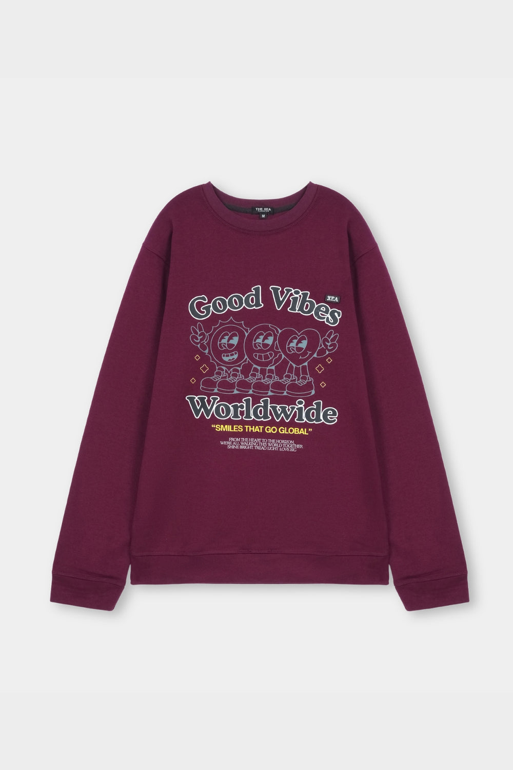 Maroon sweatshirt with 'Good Vibes Worldwide' text and cartoon characters on a light gray background