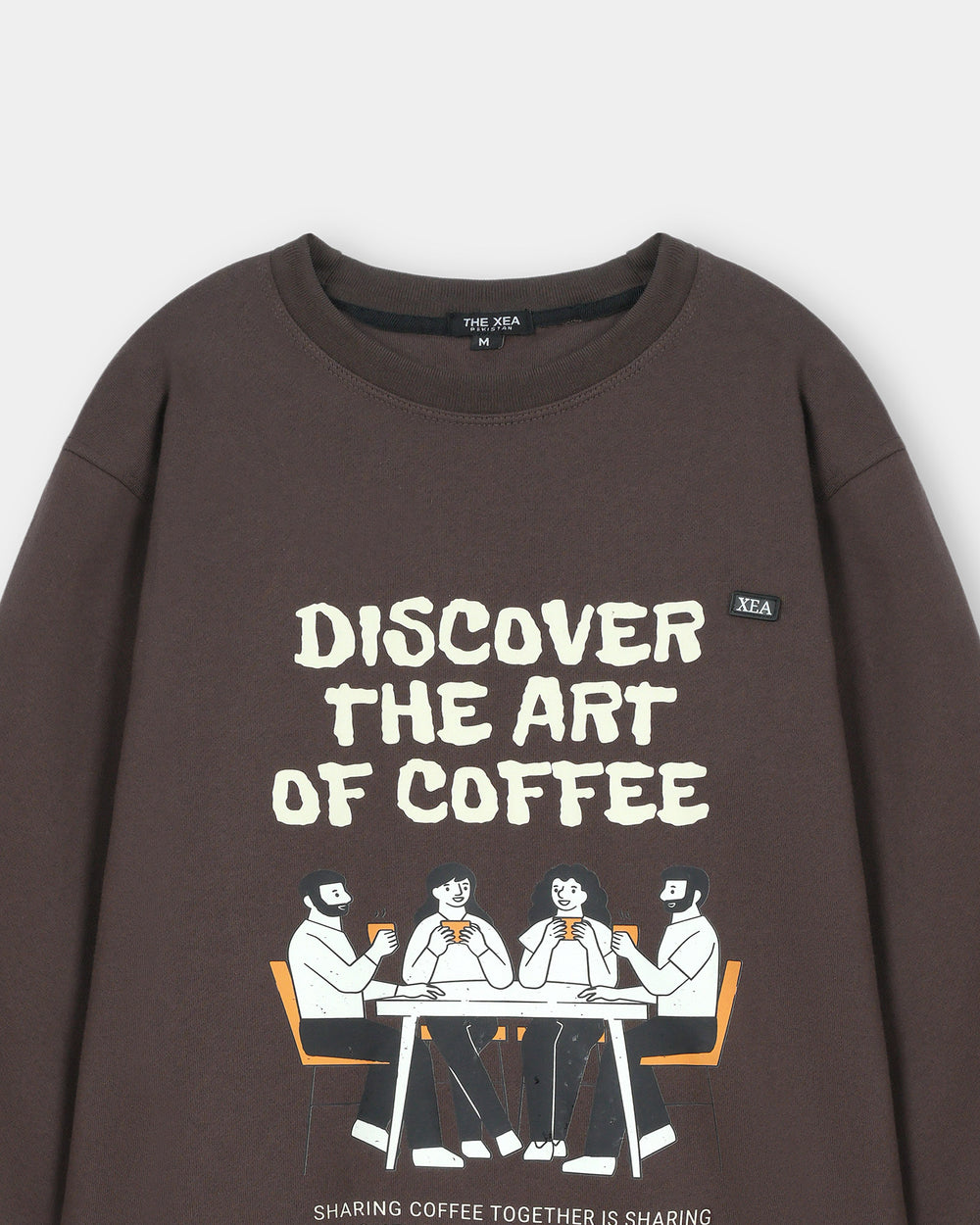 Brown sweatshirt with 'Discover the Art of Coffee' text and graphic on a white background