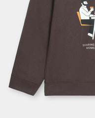 Brown sweatshirt with a graphic of a person sitting on a chair and text on a white background