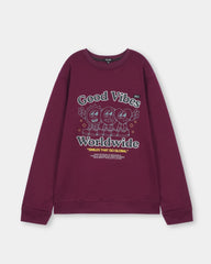 Maroon sweatshirt with 'Good Vibes Worldwide' text and cartoon characters on a light gray background